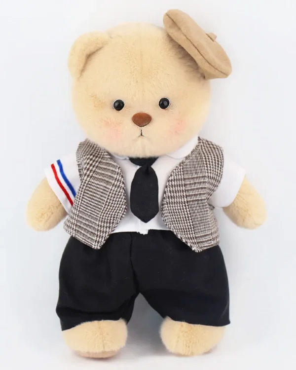 ours en peluche brun vêtu d'un costume de mariage . il est debout et vue de face.