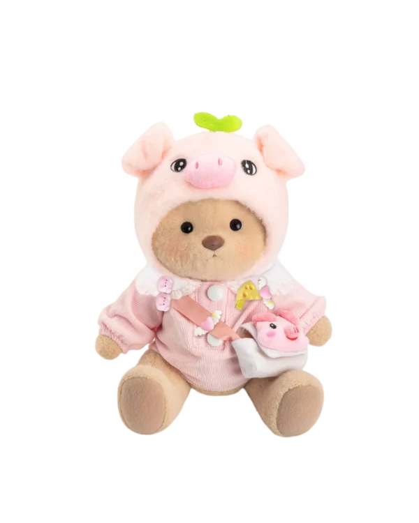 Un petit nounours brun déguisé en cochon qui est assis de face