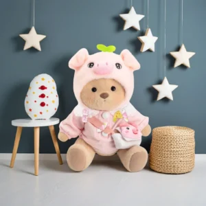 ChatGPT a dit : Peluche à habiller Petit Nounours brun déguisé en cochon, un ours en peluche dans une chambre d'enfant